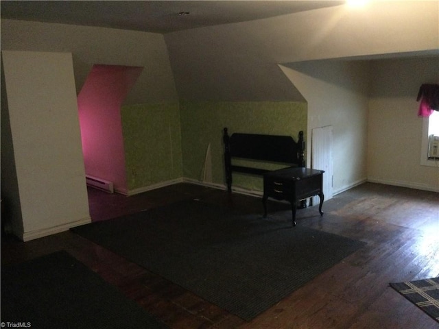 bonus room with baseboard heating, baseboards, and wood finished floors