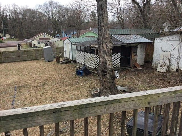 view of yard with an outdoor structure, a storage unit, and fence