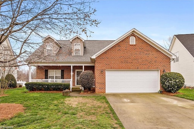 view of front of property featuring a garage, a porch, and a front lawn