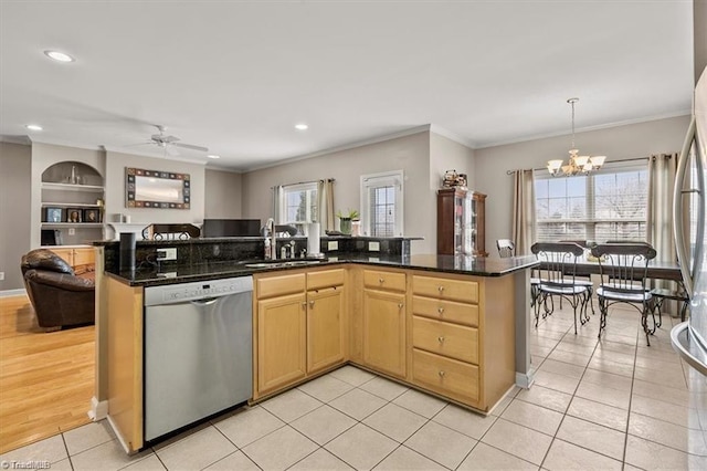 kitchen featuring sink, dishwasher, light tile patterned floors, hanging light fixtures, and built in shelves