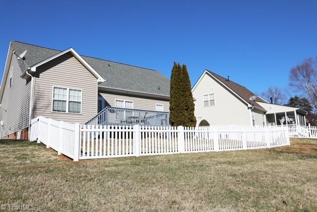 rear view of property with a lawn