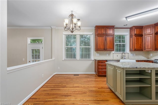 4 Beech Grove Ct, Greensboro, NC 27455 - kitchen with a chandelier, a sink, decorative backsplash, light wood-style floors, and crown molding