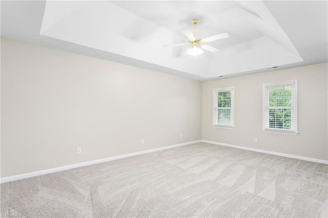4 Beech Grove Ct, Greensboro, NC 27455 - empty room featuring a tray ceiling, light carpet, baseboards, and ceiling fan