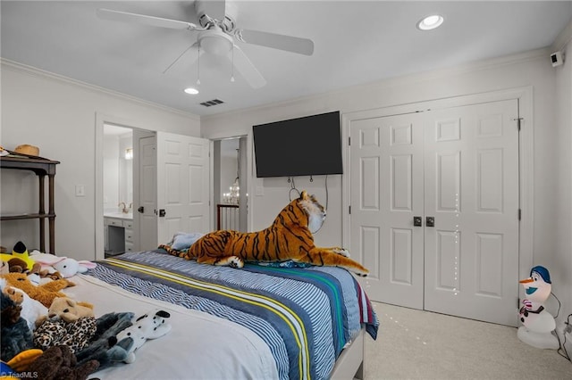 carpeted bedroom with visible vents, crown molding, recessed lighting, and a closet