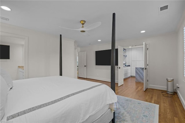 bedroom featuring wood finished floors, recessed lighting, visible vents, and baseboards