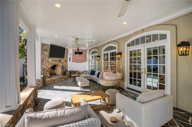living area with french doors, recessed lighting, an outdoor stone fireplace, and a ceiling fan