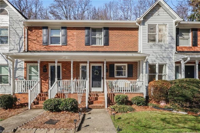 townhome / multi-family property with a porch