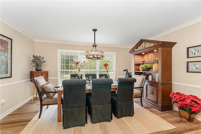 1312 Gilbrook Ct, High Point, NC 27262 - dining area featuring light wood-style floors, a chandelier, crown molding, and baseboards