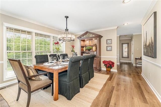 1312 Gilbrook Ct, High Point, NC 27262 - dining area with a chandelier, light wood-style flooring, baseboards, crown molding, and recessed lighting