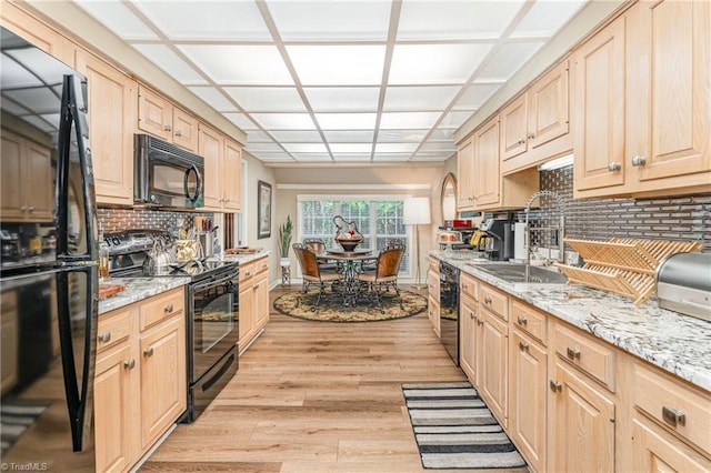 1312 Gilbrook Ct, High Point, NC 27262 - kitchen featuring black appliances, light brown cabinets, tasteful backsplash, and light wood-type flooring