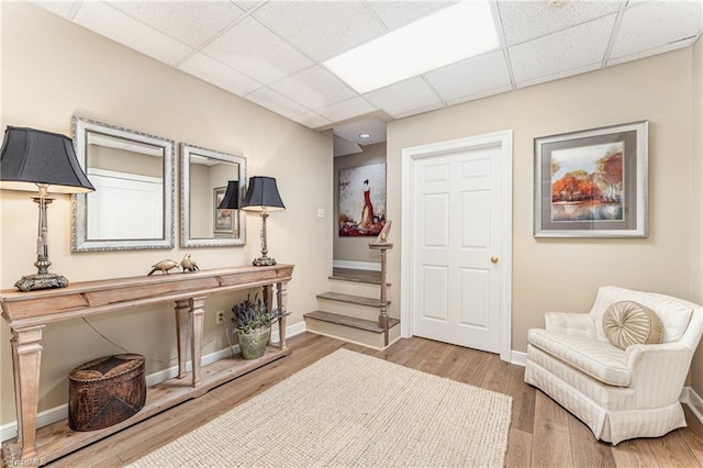 1312 Gilbrook Ct, High Point, NC 27262 - sitting room featuring a drop ceiling, baseboards, stairway, and wood finished floors