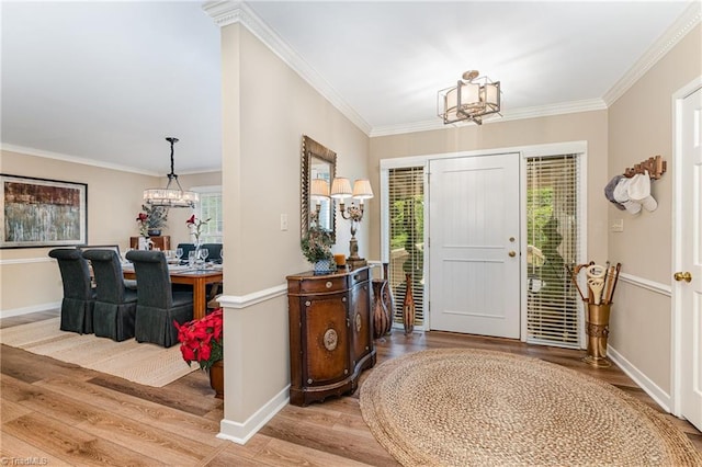 1312 Gilbrook Ct, High Point, NC 27262 - entrance foyer featuring a chandelier, light wood-style floors, plenty of natural light, and ornamental molding