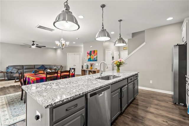 kitchen with appliances with stainless steel finishes, a sink, baseboards, gray cabinets, and dark wood finished floors