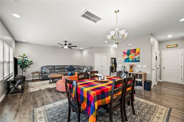 dining space with baseboards, recessed lighting, wood finished floors, a chandelier, and a ceiling fan
