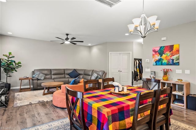 dining room featuring a chandelier, wood finished floors, recessed lighting, a ceiling fan, and baseboards