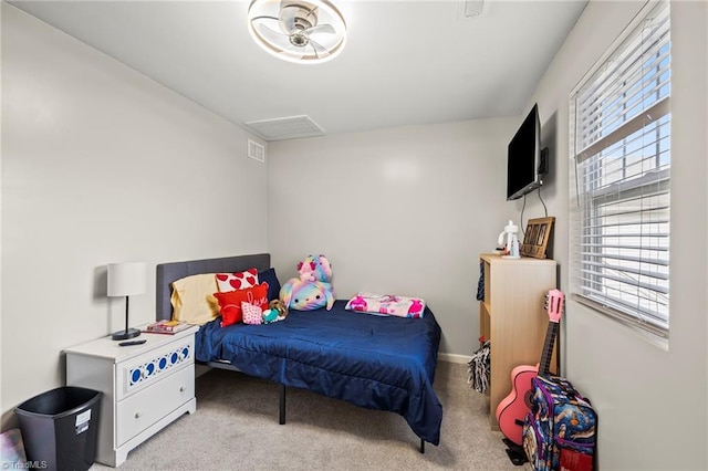 bedroom featuring multiple windows and carpet