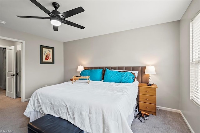 carpeted bedroom with baseboards and a ceiling fan