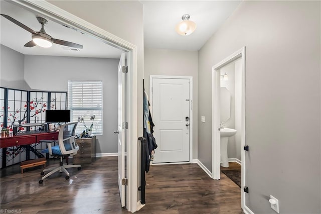 foyer entrance with dark wood-type flooring, baseboards, and a ceiling fan