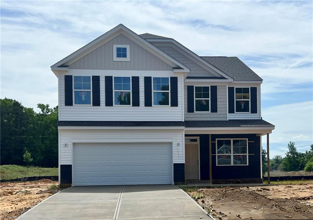717 Brooklet Ct, Winston-Salem, NC 27127 - view of front of home featuring driveway, an attached garage, a porch, and roof with shingles