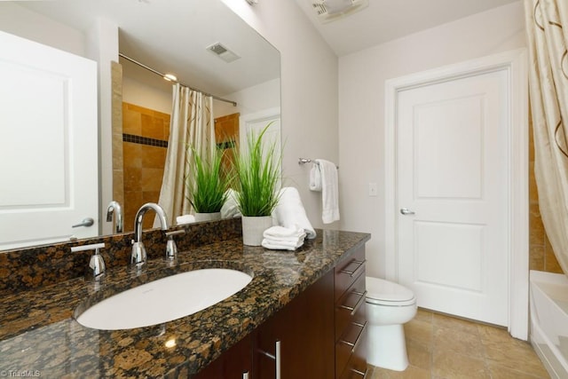 full bathroom with vanity, toilet, and visible vents