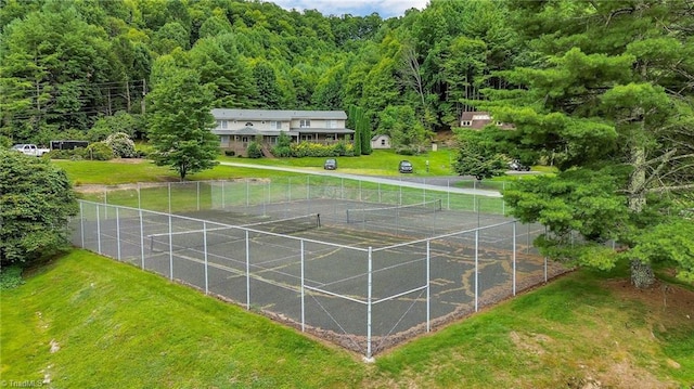 view of sport court featuring a yard