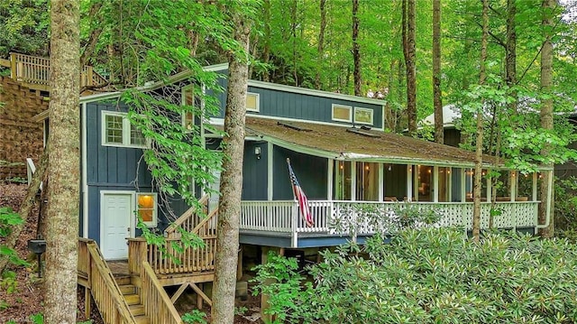 rear view of house with a wooden deck