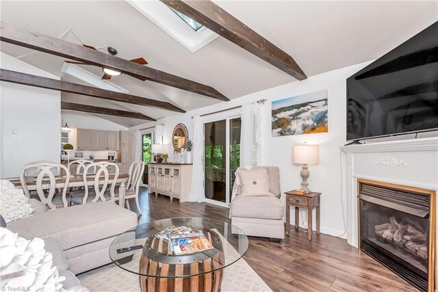 living room with vaulted ceiling with skylight and wood-type flooring