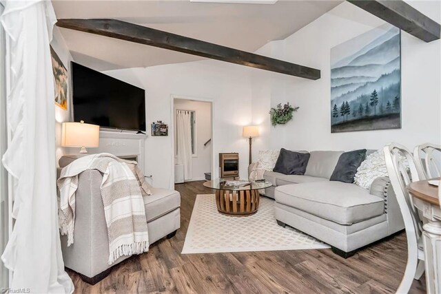 living room featuring dark wood-type flooring, high vaulted ceiling, beam ceiling, and heating unit