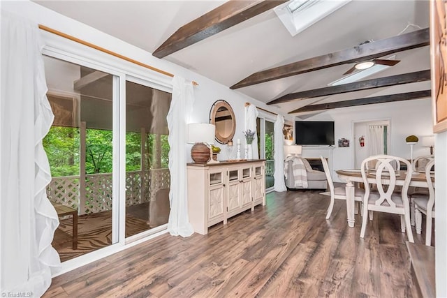 dining space featuring baseboard heating, ceiling fan, hardwood / wood-style floors, and vaulted ceiling with beams