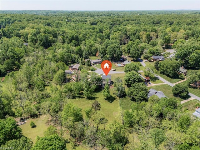 birds eye view of property with a wooded view
