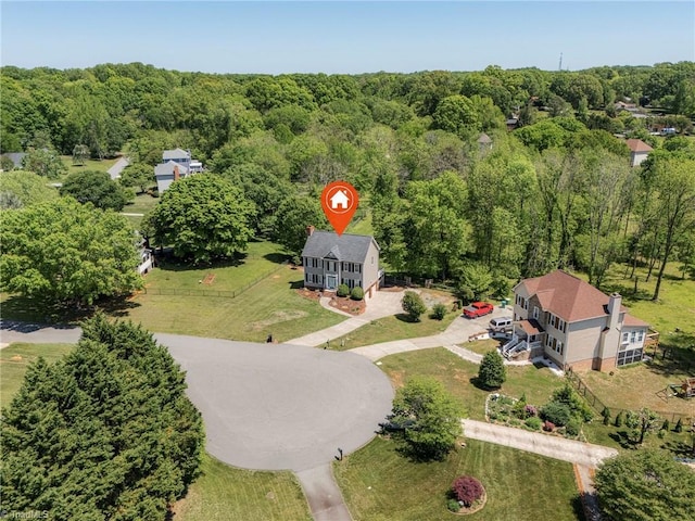 bird's eye view with a wooded view