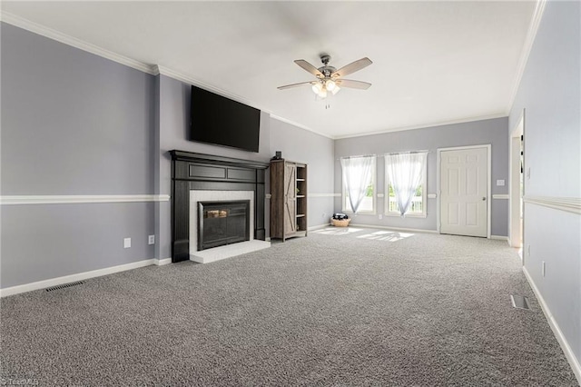unfurnished living room with crown molding, ceiling fan, a fireplace, carpet, and baseboards