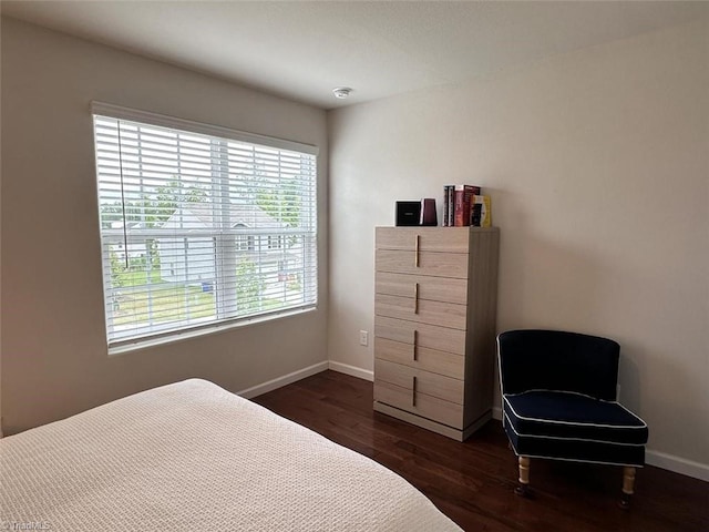 bedroom with dark hardwood / wood-style flooring