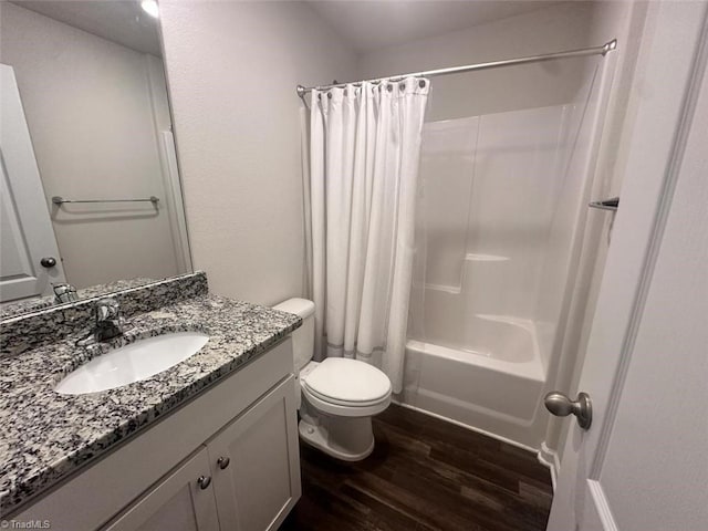 full bathroom featuring wood-type flooring, vanity, shower / tub combo with curtain, and toilet