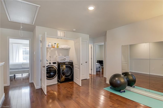 laundry room featuring hardwood / wood-style flooring and washing machine and clothes dryer