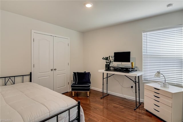 bedroom featuring dark hardwood / wood-style floors and a closet