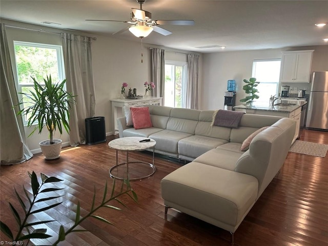 living room with ceiling fan, dark hardwood / wood-style flooring, and sink