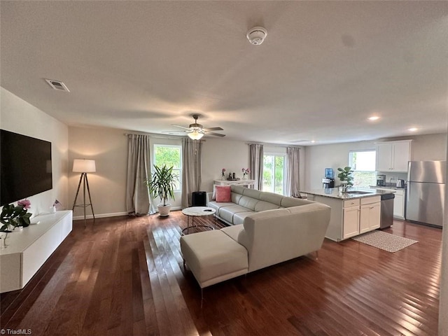 living room with ceiling fan, sink, and dark hardwood / wood-style flooring