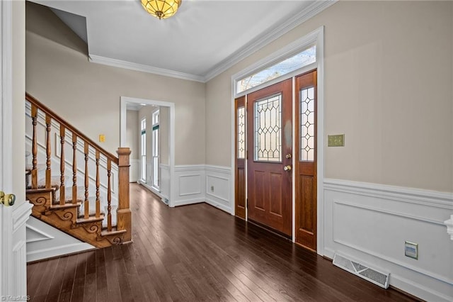 entrance foyer featuring crown molding and dark hardwood / wood-style flooring