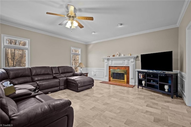 living room with a fireplace, ceiling fan, and crown molding