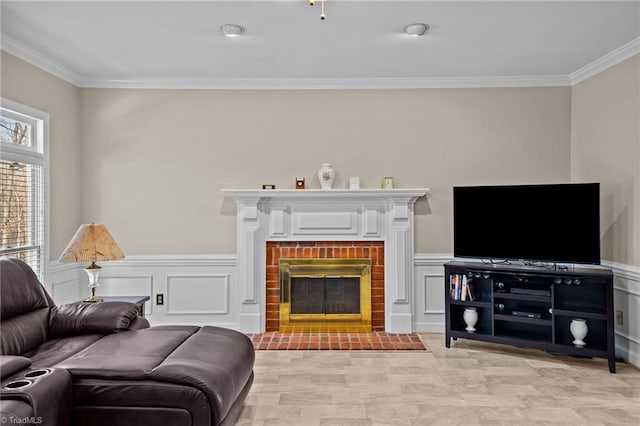 living room with a brick fireplace and ornamental molding