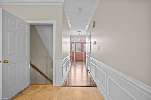 corridor featuring light hardwood / wood-style flooring and ornamental molding