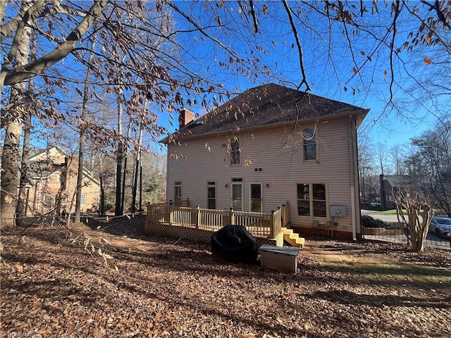 back of property with a wooden deck