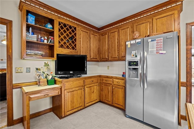 kitchen with decorative backsplash and stainless steel refrigerator with ice dispenser