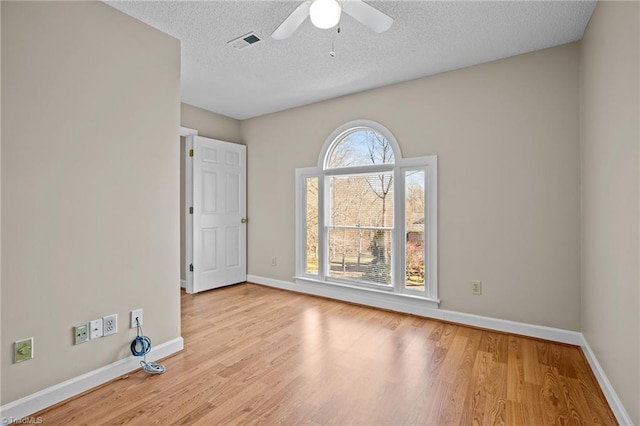 unfurnished room with ceiling fan, light hardwood / wood-style floors, and a textured ceiling