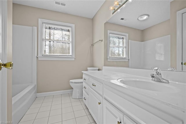 full bathroom with tile patterned floors, vanity, a healthy amount of sunlight, and toilet