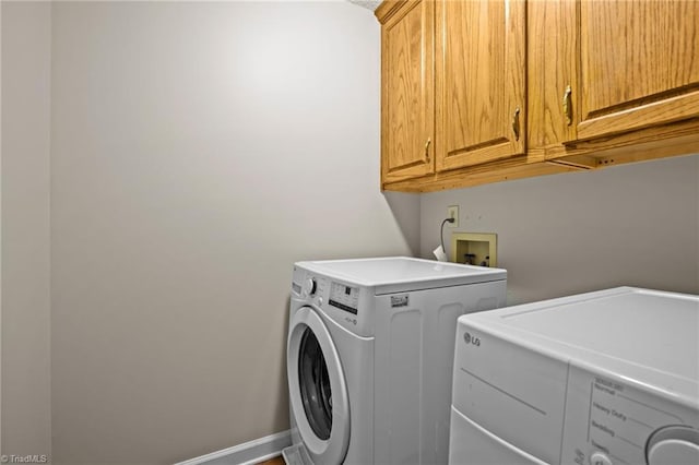 washroom with cabinets and separate washer and dryer