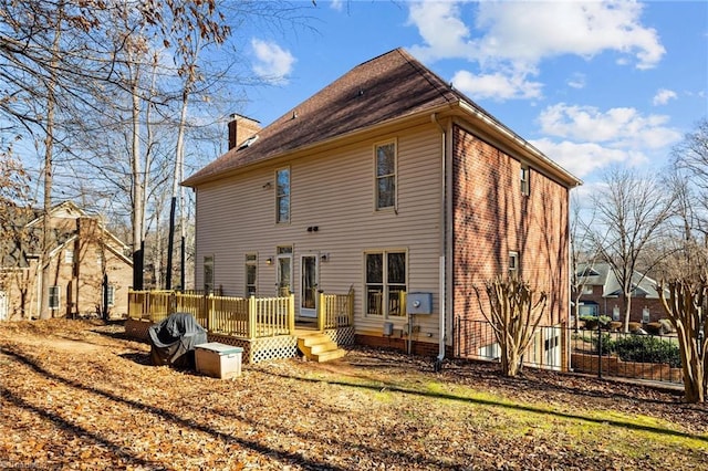 back of house with a deck