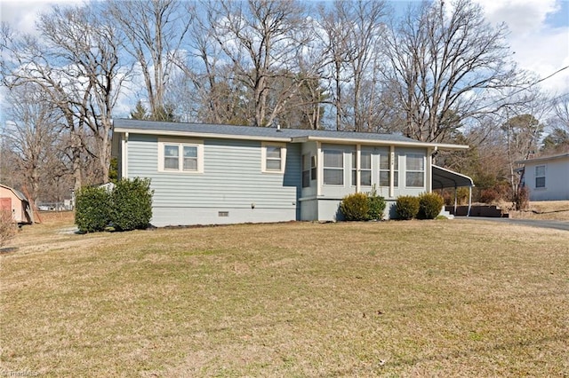 view of front of house with a front yard and a carport