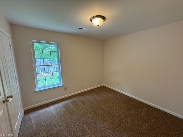 8 Franklinwood Dr, Greensboro, NC 27401 - spare room with baseboards and dark colored carpet